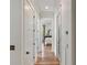 Hallway featuring hardwood floors and neutral walls, leading to a bright bedroom at 121 W Shipyard Rd, Mount Pleasant, SC 29464