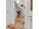 Elegant hallway featuring hardwood floors and a staircase with decorative iron railings at 121 W Shipyard Rd, Mount Pleasant, SC 29464