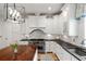 Well-lit kitchen featuring white cabinetry, stainless steel appliances, and a wooden island countertop at 121 W Shipyard Rd, Mount Pleasant, SC 29464