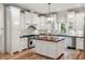 Modern kitchen with white cabinets, wood island, stainless appliances, and pendant lighting at 121 W Shipyard Rd, Mount Pleasant, SC 29464