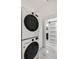 Bright laundry area showcases a stacked washer/dryer and access to a stylish bathroom at 121 W Shipyard Rd, Mount Pleasant, SC 29464