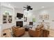 Bright living room boasts a fireplace, built-in shelving, and sleek ceiling fan at 121 W Shipyard Rd, Mount Pleasant, SC 29464