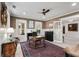 A distinguished office with a wooden desk and an area rug, illuminated by natural light and a unique ceiling fan at 121 W Shipyard Rd, Mount Pleasant, SC 29464