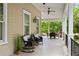 Inviting porch with rocking chairs and ceiling fan, perfect for relaxing outdoors at 121 W Shipyard Rd, Mount Pleasant, SC 29464