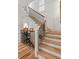 Elegant staircase with light wood treads, white risers, and an ornate black iron railing at 121 W Shipyard Rd, Mount Pleasant, SC 29464