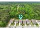 Aerial shot of a neighborhood surrounded by lush greenery and mature trees with a pin for location at 1221 Lois Allen Rd, Johns Island, SC 29455