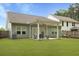 Large backyard featuring a covered patio with outdoor seating and a well-manicured lawn at 1221 Lois Allen Rd, Johns Island, SC 29455