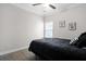 Modern bedroom with gray walls, ceiling fan, two framed pictures, and a window for natural light at 1221 Lois Allen Rd, Johns Island, SC 29455