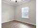 Bright bedroom with a large window and blinds, ceiling fan, and wood laminate flooring at 1221 Lois Allen Rd, Johns Island, SC 29455