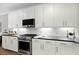 Modern kitchen featuring white cabinets, stainless steel appliances, and sleek countertops at 1221 Lois Allen Rd, Johns Island, SC 29455
