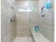 Contemporary walk-in shower with gray tile, a built-in bench, and a rainfall showerhead at 1221 Lois Allen Rd, Johns Island, SC 29455