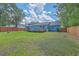 View of the home's backyard, showcasing a large deck and extensive lawn area with mature trees at 1325 Edward Dr, Moncks Corner, SC 29461