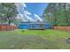 A sprawling backyard boasts a well-maintained lawn, wooden fencing, and mature trees providing ample shade at 1325 Edward Dr, Moncks Corner, SC 29461