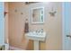 Charming powder room featuring a pedestal sink, decorative mirror, and beach-themed accents at 1325 Edward Dr, Moncks Corner, SC 29461