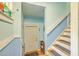 Inviting entryway with blue beadboard, staircase, and a white front door at 1325 Edward Dr, Moncks Corner, SC 29461