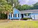 Charming light-blue single-story home with a landscaped front yard and a cozy, inviting front porch at 1325 Edward Dr, Moncks Corner, SC 29461