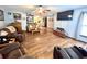 Spacious living room featuring hardwood floors, comfortable furnishings, and a seamless transition to the kitchen at 1325 Edward Dr, Moncks Corner, SC 29461