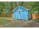 Backyard shed painted blue, with a quaint garden in a peaceful setting at 1325 Edward Dr, Moncks Corner, SC 29461