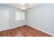 Inviting bedroom with wood-look floors, a ceiling fan, and a window for natural light and ventilation at 133 Tall Spruce Rd, Moncks Corner, SC 29461