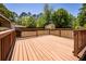 Large wooden deck overlooks a spacious yard with mature trees and natural sunlight at 133 Tall Spruce Rd, Moncks Corner, SC 29461