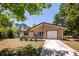 Charming house with brick facade, well-maintained lawn, and a driveway leading to an attached garage at 133 Tall Spruce Rd, Moncks Corner, SC 29461