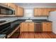 Kitchen featuring wooden cabinets, stainless steel appliances, and dark countertops at 133 Tall Spruce Rd, Moncks Corner, SC 29461