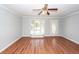 Bright living room featuring hardwood floors, a bay window, and a ceiling fan at 133 Tall Spruce Rd, Moncks Corner, SC 29461