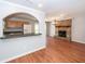 Open floor plan with archway to kitchen and brick fireplace at 133 Tall Spruce Rd, Moncks Corner, SC 29461