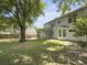 Large backyard featuring a patio, sunroom, and mature trees offering plenty of shade at 1410 Diamond Boulevard, Mount Pleasant, SC 29466