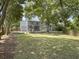 Spacious backyard featuring a patio, fire pit, large trees, and lush green grass at 1410 Diamond Boulevard, Mount Pleasant, SC 29466