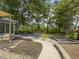 Expansive backyard with a patio, a fire pit, and mature trees at 1410 Diamond Boulevard, Mount Pleasant, SC 29466