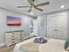 Cozy bedroom with ceiling fan, dresser, and a TV, plus an open door at 1410 Diamond Boulevard, Mount Pleasant, SC 29466