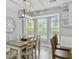 Bright dining room with large windows, modern light fixture, and a stylish dining table at 1410 Diamond Boulevard, Mount Pleasant, SC 29466