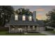 Beautiful home featuring a welcoming front porch and a two car garage, set against a twilight sky at 1410 Diamond Boulevard, Mount Pleasant, SC 29466