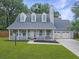 Charming home with a covered porch, dormer windows, and a well-manicured lawn at 1410 Diamond Boulevard, Mount Pleasant, SC 29466