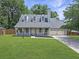 Charming home featuring a well-manicured lawn, dormer windows, and a two-car garage at 1410 Diamond Boulevard, Mount Pleasant, SC 29466