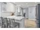 Beautiful kitchen with white cabinets, stainless steel appliances, and a breakfast bar with seating at 1410 Diamond Boulevard, Mount Pleasant, SC 29466