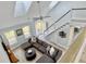 Sunlit living room with high ceilings, a large sectional sofa, and an open staircase at 1410 Diamond Boulevard, Mount Pleasant, SC 29466