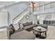 Bright, open-concept living area features soaring ceilings, modern staircase, and stylish gray sectional sofa at 1410 Diamond Boulevard, Mount Pleasant, SC 29466