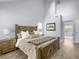 Spacious main bedroom with high ceilings, wood floors, and a view to the bathroom at 1410 Diamond Boulevard, Mount Pleasant, SC 29466