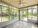 Bright sunroom with multiple windows offering views of the backyard, tiled floor, and ceiling fan at 1410 Diamond Boulevard, Mount Pleasant, SC 29466