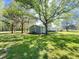 Expansive backyard featuring a well-maintained lawn, mature trees, and a charming exterior view at 1425 Risher Mountain Rd, Walterboro, SC 29488