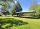 Backyard area features grass, metal carport, and mature trees providing ample shade at 1425 Risher Mountain Rd, Walterboro, SC 29488