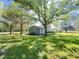 Expansive backyard featuring a well-maintained lawn, mature trees, and a charming exterior view at 1425 Risher Mountain Rd, Walterboro, SC 29488