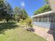 Well maintained backyard featuring brick walkway leading to screened-in porch at 1425 Risher Mountain Rd, Walterboro, SC 29488