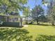 Lush green lawn and screened porch are perfect for enjoying outdoors at 1425 Risher Mountain Rd, Walterboro, SC 29488