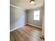 This bedroom features fresh paint, wood floors, and a window for natural light at 1425 Risher Mountain Rd, Walterboro, SC 29488