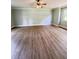 Large primary bedroom with wood-look floors and ceiling fan at 1425 Risher Mountain Rd, Walterboro, SC 29488