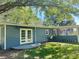 Back of home featuring double doors, manicured lawn and screened porch at 1425 Risher Mountain Rd, Walterboro, SC 29488