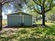 Side exterior featuring backyard trees and a blue wall, air conditioner, and white trim at 1425 Risher Mountain Rd, Walterboro, SC 29488